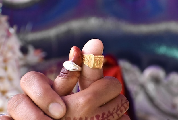 Newly married indian couples holding each other hand showing their rings