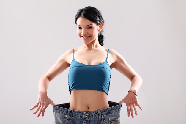 Free photo portrait of a woman showing her weight loss